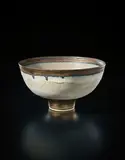 Footed bowl by Lucie Rie, circa 1978, Stoneware, inlaid green lines, golden manganese bands, sold Dec 2016