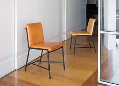 Pair of side chairs by Jacques Adnet, 1950s, Painted steel, leather, sold Dec 2016
