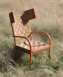 Frits Schlegel, Rare wingback armchair, circa 1930, Painted wood, straw cord, patinated brass
