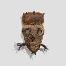 Dan, Poro Society mask, carved wood with encrustation, fur, iron, shell