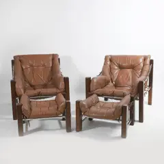 Jean Gillon, Pair of 'Amazonas' easy chairs, 1960s, rosewood framed with slung leather upholstered cushions