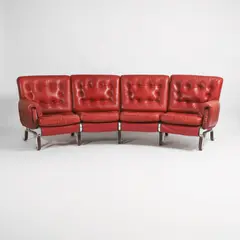 Eric Sigfrid Persson, Four-seater curved sofa, red leather seats raised on a brushed steel frame