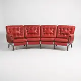 Eric Sigfrid Persson, Four-seater curved sofa, red leather seats raised on a brushed steel frame