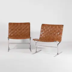 Ross Littell, Pair of 'PLR 1' lounge chairs, the stainless steel frame with tan pleated leather seats (2)