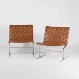 Ross Littell, Pair of 'PLR 1' lounge chairs, the stainless steel frame with tan pleated leather seats (2)