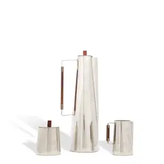Early Three-Piece Coffee Set by Paul Evans, for Raymor, pewter, rosewood, underside of each impressed with Pewter Denmark and Raymor stamps, offered Oct 2025