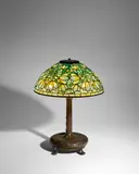 'Crocus' Table Lamp by Tiffany Studios, leaded glass, patinated bronze, shade tag-stamped 'TIFFANY STUDIOS NEW YORK', base stamped 'TIFFANY STUDIOS', sold Jun 2025