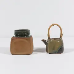 Grand pot et théière by Pierre Culot, A large pot and a tea pot in glazed stoneware and rattan by Pierre Culot circa 1982 and 1988-1990 with the artist's seal, sold Oct 2025