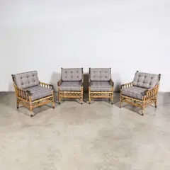 Ensemble de quatre fauteuils d'extérieur by Travail Français, A set of four French outdoor armchairs in rattan, brass and upholstery, sold Jul 2025