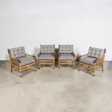 Travail Français, Ensemble de quatre fauteuils d'extérieur, A set of four French outdoor armchairs in rattan, brass and upholstery