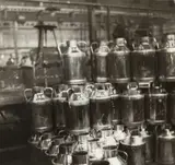 Germaine Krull, Cans for the delivery of milk, Paris c. 1930, from the series 'Les Ouvrières des Paris