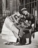 Erich Lessing, The Clown Frank Billerbeck reading a pin-up magazine, Paris 1952, 1952, Vintage silver print on glossy single-weight paper, in very good condition. Photographer's "Magnum" agency stamp, also "Publifoto Milano" agency stamp and stamped "OA28578" on the reverse. In memory o