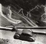 Hans Truöl, Volkswagen Beetle at 'Passo Stelvio' panorama road, Italy c. 1955, 1955, Gelatin silver print, printed later on single-weight ferrotyped paper