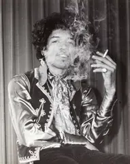 George Tremlett, Jimi Hendrix smoking, 1967, Vintage silver print on single-weight ferrotyped paper, in very good condition. Photographer's stamp, "Redaktion Archiv" stamp and annotated "Jimi Henrix" in blue felt-tip pen on the reverse. George T