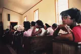 William Eggleston, Como, Mississippi (Black women in church), 1972, Dye transfer print from Dust Bells Vol. I , printed 2004