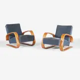 Pair of model 'no. 400' 'Tank' lounge chairs by Alvar Aalto, 1936, each upholstered in blue velvet, sold Oct 2025