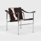 'LC1' armchair by Charles-Édouard Jeanneret aka 'Le Corbusier', 1929, upholstered in cowhide over a chrome frame with black leather armrests, sold Oct 2025