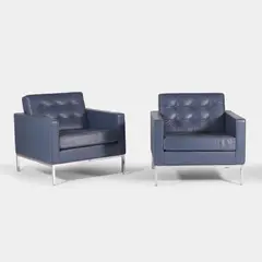 Florence Knoll, Pair of lounge chairs, each upholstered in navy-blue leather with grey piping