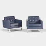Florence Knoll, Pair of lounge chairs, each upholstered in navy-blue leather with grey piping