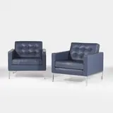 Florence Knoll, Pair of lounge chairs, each upholstered in navy-blue leather with grey piping