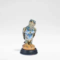 Robert Wallace Martin, for Martin Brothers, circa 1914, Glazed earthenware, decorated in blues, ochre and tan against a buff ground, on an ebonised wooden base