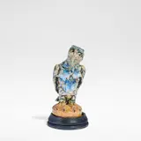 Robert Wallace Martin, for Martin Brothers, circa 1914, Glazed earthenware, decorated in blues, ochre and tan against a buff ground, on an ebonised wooden base