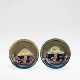 William Moorcroft, 'Claremont', pair of plates, circa 1915, Glazed stoneware, raised slip motifs of mushrooms against a green and blue mottled ground
