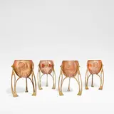 Wmf, Set of four Art Nouveau cachepots, circa 1910, Copper and brass, the spherical pots decorated with shells in relief, raised on pierced cast brass supports