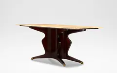 Osvaldo Borsani, Dining table, circa 1950, Pink marble and mahogany, the shaped top raised on a waisted base terminating onto splayed supports