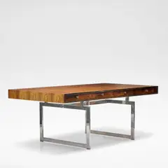 Bodil Kjaer, for E. Pedersen & Son, Rosewood and chromed metal, the rectangular top with four recessed frieze drawers, raised on rectangular chromed metal supports