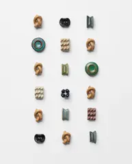 Eighteen buttons by Lucie Rie, circa 1945-1950, Stoneware, various glazes, sold Jun 2025