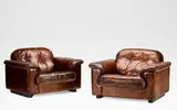 De Sede, 'DS101', pair of reclining lounge chairs, 1970, Upholstered in chestnut leather with buttoned backrests, the edges with stitched detailing