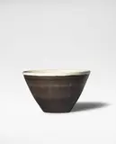 Bowl by Lucie Rie, circa 1955, Stoneware, manganese glaze with sgraffito design, white glaze to interior and rim, sold Oct 2024
