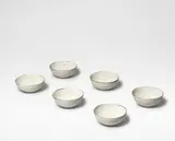 Untitled by Lucie Rie, Stoneware, shiny white glaze with feathered manganese rim, sold Oct 2024