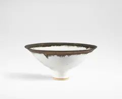 Large footed bowl by Lucie Rie, circa 1980, Stoneware, matt white glaze with golden manganese rim, sold Oct 2024