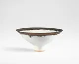 Large footed bowl by Lucie Rie, circa 1980, Stoneware, matt white glaze with golden manganese rim, sold Oct 2024