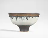 Footed bowl by Lucie Rie, circa 1980-1981, Porcelain, grey glazes with inlaid radiating lines, turquoise and manganese bands, sold Oct 2024