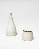 Pepper and mustard pot by Lucie Rie, circa 1956, Stoneware, shiny white glaze with manganese rim and top, cork, sold Oct 2024