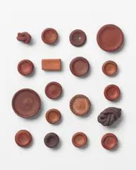 Eighteen buttons by Lucie Rie, circa 1945-1950, Unglazed earthenware in tones of brown and terracotta, sold Oct 2024