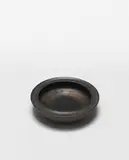 Ashtray by Lucie Rie, circa 1972, Stoneware, manganese glaze, sold Apr 2024