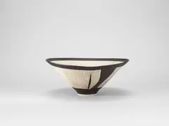 Conical bowl by Lucie Rie, circa 1972, Porcelain, radiating inlaid lines, manganese bands to rim and foot, sold Apr 2024