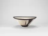Conical bowl by Lucie Rie, circa 1972, Porcelain, radiating inlaid lines, manganese bands to rim and foot, sold Apr 2024