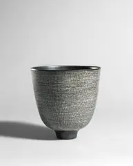 Deep bowl by Rupert Spira, circa 2003, Stoneware, fine vertical lines incised through black pigment over white glaze, sold Apr 2024