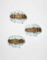 Max Ingrand, Set of three wall lights, model no. 2496, circa 1968, Chiseled crystal glass, bronze, painted metal