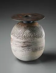 Ovoid pot with disc by Hans Coper, circa 1965, Stoneware, layered white porcelain slips and engobes over a body with textured and incised linear designs, the neck and , sold Dec 2015