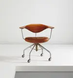 Early swivel chair, model no. JH502 by Hans J. Wegner, circa 1955, Teak, chromium-plated metal, leather, Bakelite, sold Dec 2015