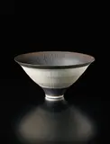 Conical bowl by Lucie Rie, circa 1978, Porcelain, golden manganese glaze, radiating inlaid and sgraffito design, sold Dec 2015