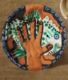 Pablo Picasso, Mains au poisson (Hands with Fish), 1953, Red earthenware round dish painted in colors, engraved and partially glazed,