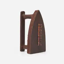 Cadeau by Man Ray, iron and brass nails, sold Dec 2025