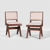 Pair of side chairs by Pierre Jeanneret, each of teak with cream upholstery, sold Jul 2025